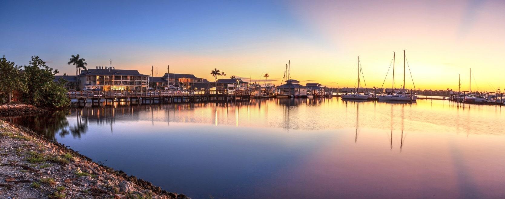 Sunrise over the water with Olde Naples waterfront homes in foreground